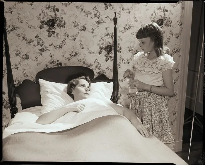 Framed Print : Girl Stands at Bedside of Sick Woman Framed Print : Girl Stands at Bedside of Sick Woman