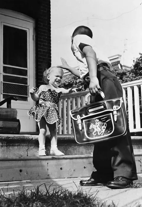 Framed Print : Girl on Steps Crying and Reaching for Her School Aged Sibling in Yard Framed Print : Girl on Steps Crying and Reaching for Her School Aged Sibling in Yard