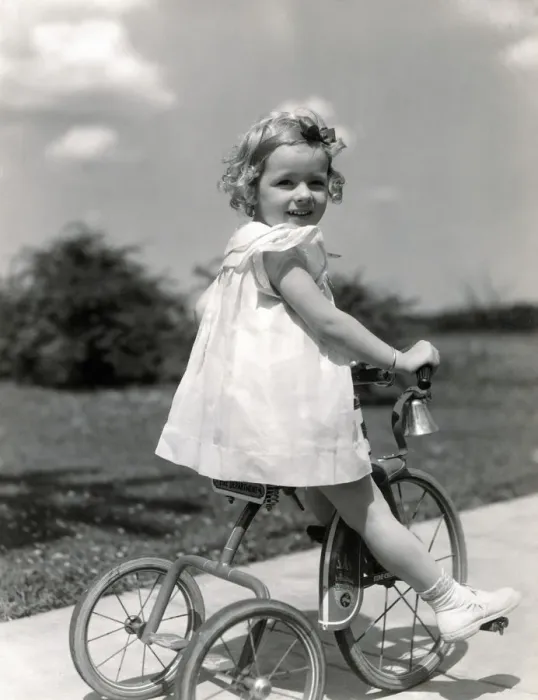 Framed Print : Girl wearing summer dress, riding tricycle down sidewalk. (Photo by H. Armstrong Roberts  /  Retrofile  /  Getty Images)