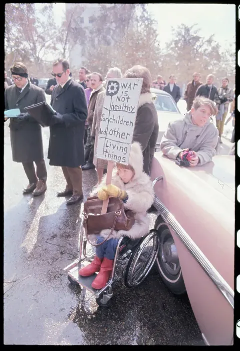 Framed Print : Girl in Wheelchair Holding Anti-War Sign Framed Print : Girl in Wheelchair Holding Anti-War Sign