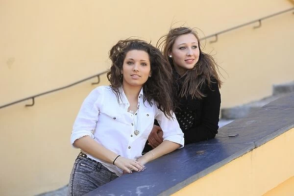 Two girlfriends, teenagers, posing on a staircase, Menton, Alpes-Maritimes, Provence-Alpes-Cote dAzur, France