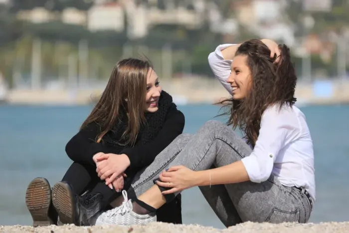 Framed Print : Two girlfriends, teenagers, sitting on the beach, Menton, Alpes-Maritimes, Provence Alpes, France Framed Print : Two girlfriends, teenagers, sitting on the beach, Menton, Alpes-Maritimes, Provence Alpes, France