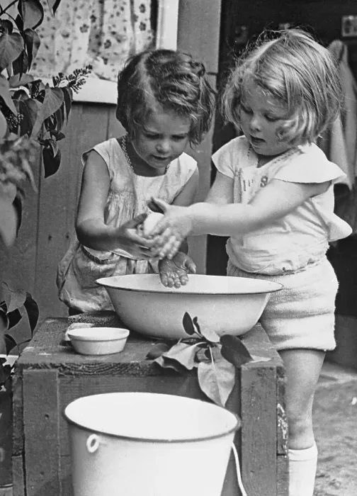 Framed Print : Girls (6-7) washing hands in wash bowl Framed Print : Girls (6-7) washing hands in wash bowl