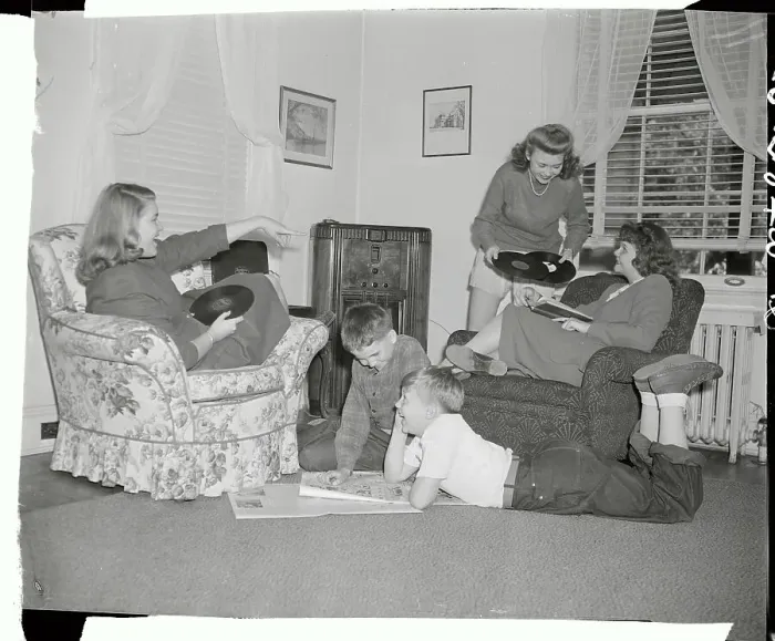 Framed Print : Girls Choosing Records with Boys Reading Comics Framed Print : Girls Choosing Records with Boys Reading Comics