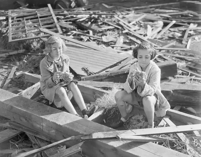 Framed Print : Girls Pick At Debris From Home Framed Print : Girls Pick At Debris From Home