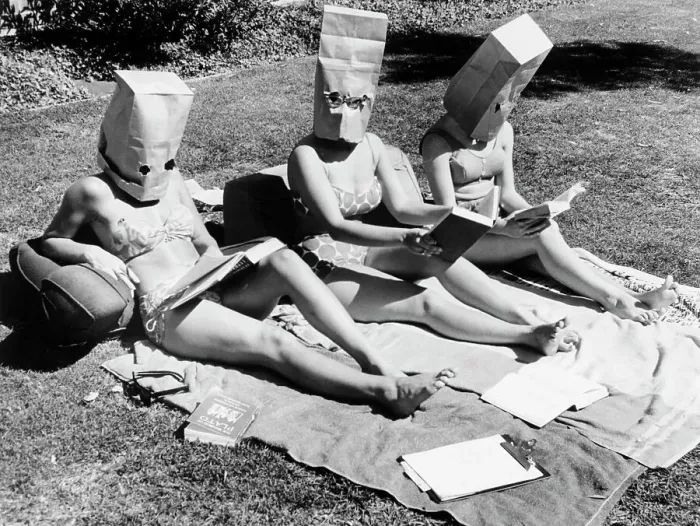 Framed Print : Girls Sunbathing with Paper Bags on Heads Framed Print : Girls Sunbathing with Paper Bags on Heads