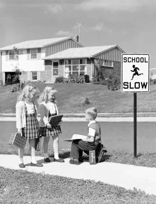 Framed Print : Two girls walking to school, boy sitting on lunchbox. (Photo by H Framed Print : Two girls walking to school, boy sitting on lunchbox. (Photo by H