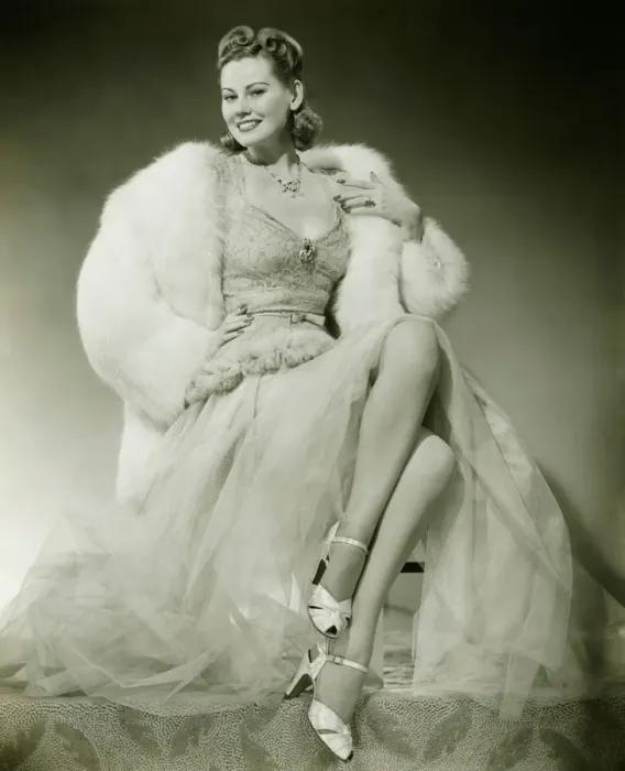 Framed Print : Glamorous woman in evening dress showing legs, posing in studio, (B&W), portrait Framed Print : Glamorous woman in evening dress showing legs, posing in studio, (B&W), portrait