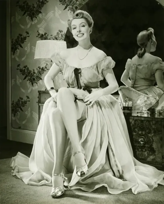 Framed Print : Glamorous woman in evening gown showing legs, (B&W), portrait Framed Print : Glamorous woman in evening gown showing legs, (B&W), portrait