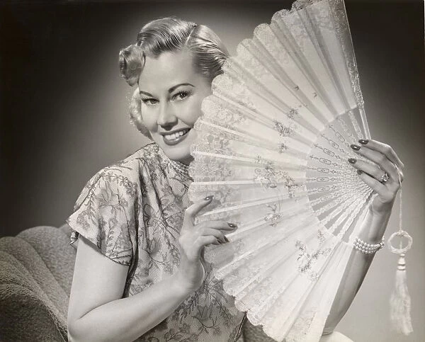 Glamorous woman with lace fan