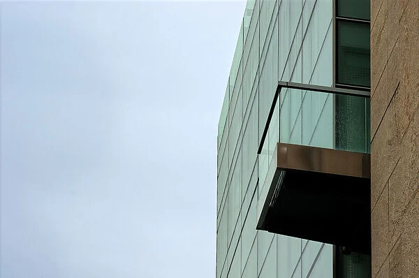 Glass Sky. A color photograph of a commercial building with a balcony in downtown Portland