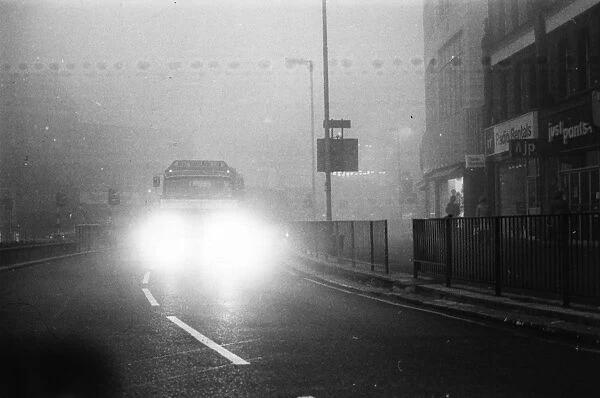 Going Where?. 18th December 1975: A lorry with headlights on moving through thick fog