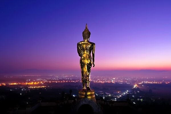 The golden standing buddha statue in Nan