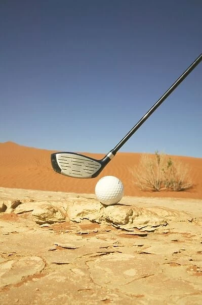 Golf Club and Ball on a Barren Desert Floor