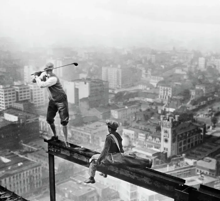Framed Print : Golfer Teeing Off on Girder High Above City Framed Print : Golfer Teeing Off on Girder High Above City