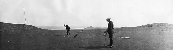 Golfers. April 1901: Two men play golf at Bamburgh Castle, Northumberland