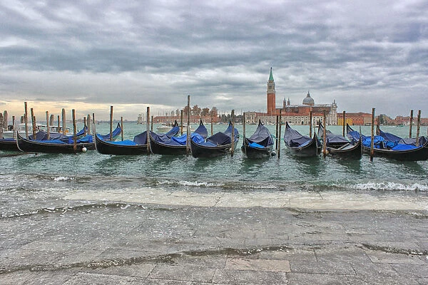 Gondolas on flooded waterfront, Venice