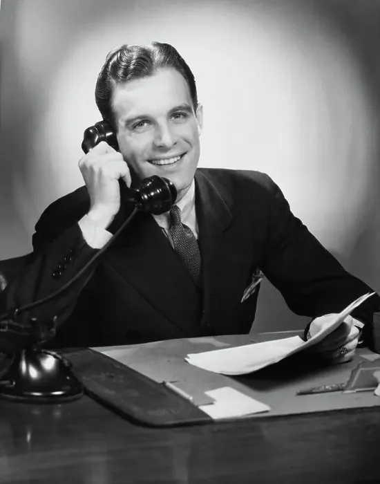 Framed Print : Good News. A businessman smiling during a phone call at his desk, circa 1940 Framed Print : Good News. A businessman smiling during a phone call at his desk, circa 1940