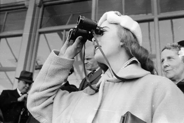 Framed Print : Good View. 18th April 1955: A woman peers at the racecourse through her binoculars Framed Print : Good View. 18th April 1955: A woman peers at the racecourse through her binoculars