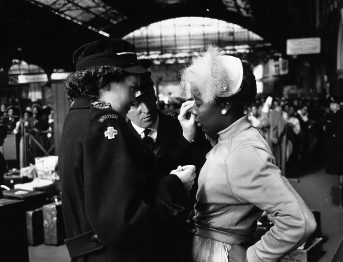 Framed Print : Got It. 27th May 1956: A Red Cross worker helps a young West Indian immigrant