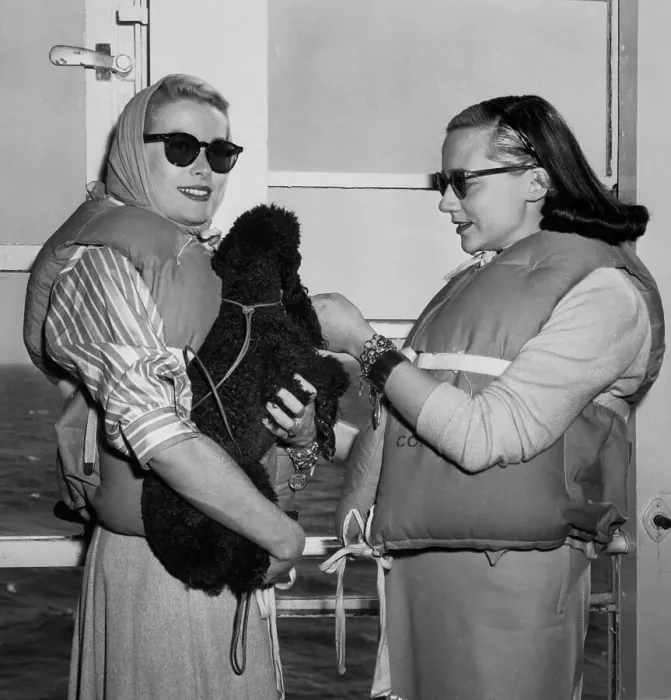 Framed Print : Grace Kelly Holding a Poodle Framed Print : Grace Kelly Holding a Poodle