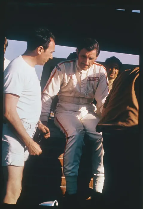 Framed Print : Graham Hill Talking to Pit Mechanic