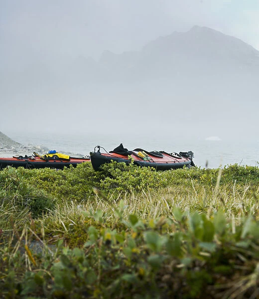 Greenland, Tasiilaq, sea kayaks on misty morning
