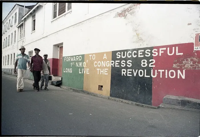 Framed Print : Grenadians Walk Past A Revolution Mural Framed Print : Grenadians Walk Past A Revolution Mural