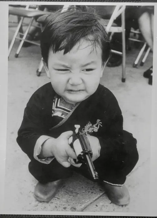 Framed Print : Grimacing Child Holding a Plastic Gun