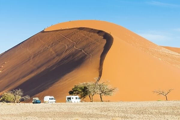 Ground view of the world famous Dune 45 with tourists. Sossuvlei, Namibia