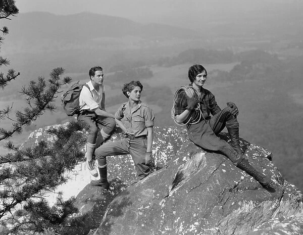 Group of three climbers atop mountain