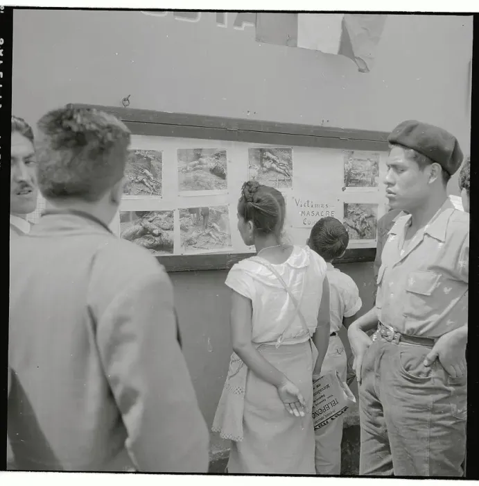 Framed Print : Group Looking at Photos on Wall Framed Print : Group Looking at Photos on Wall