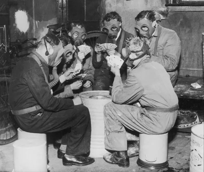 Framed Print : Group of men playing cards, wearing gas masks (B&W) Framed Print : Group of men playing cards, wearing gas masks (B&W)