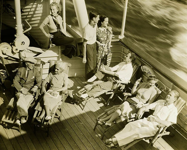 Group of people relaxing on deck of cruise ship, (B&W), (High angle view)