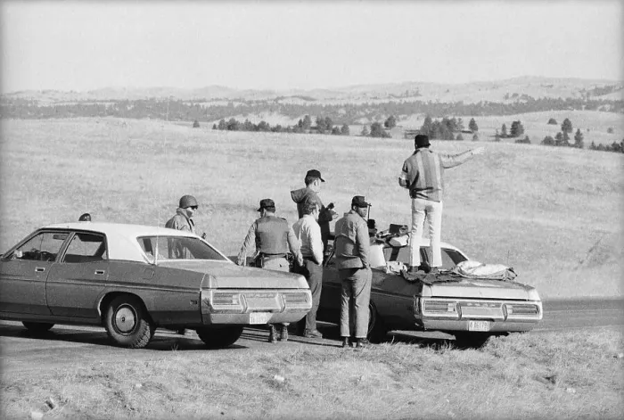Framed Print : Group Surrounding Man Standing On Car Framed Print : Group Surrounding Man Standing On Car