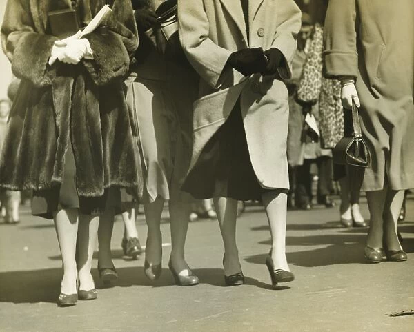 Group of women walking on street, (B&W), (Low section)