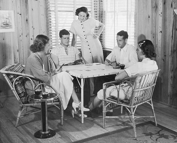 Group of young people playing cards (B&W)