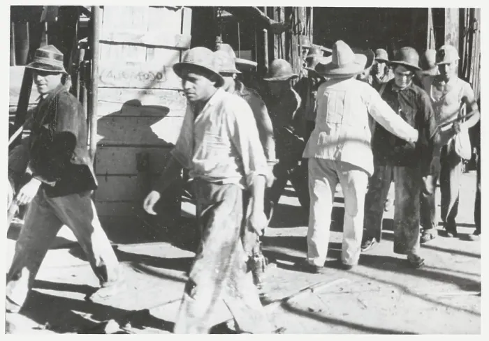 Framed Print : Guard Frisking Workers Framed Print : Guard Frisking Workers