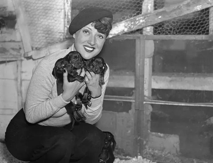 Framed Print : Gypsy Rose Lee Holding Three Puppies Framed Print : Gypsy Rose Lee Holding Three Puppies
