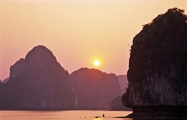 Ha Long Bay, sunset with karst formations