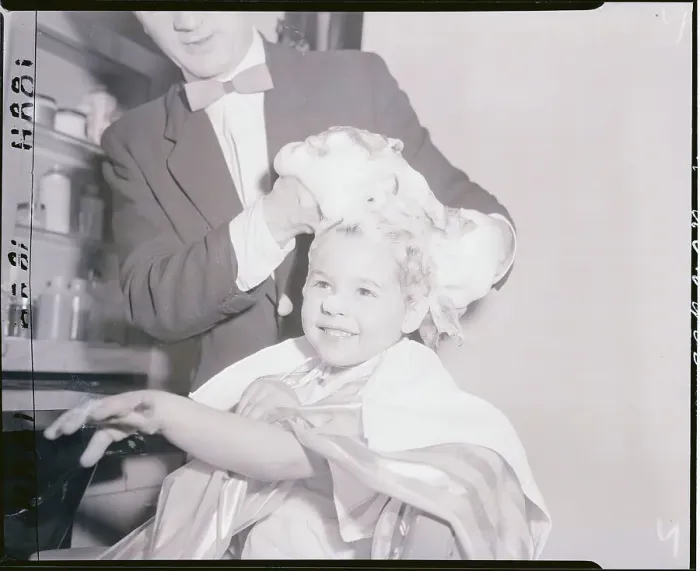 Framed Print : Hair Stylist Shampooing a Girl's Hair Framed Print : Hair Stylist Shampooing a Girl's Hair