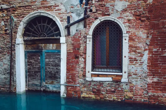 Framed Print : Half sunken door of townouse by the canal in Venice, Italy