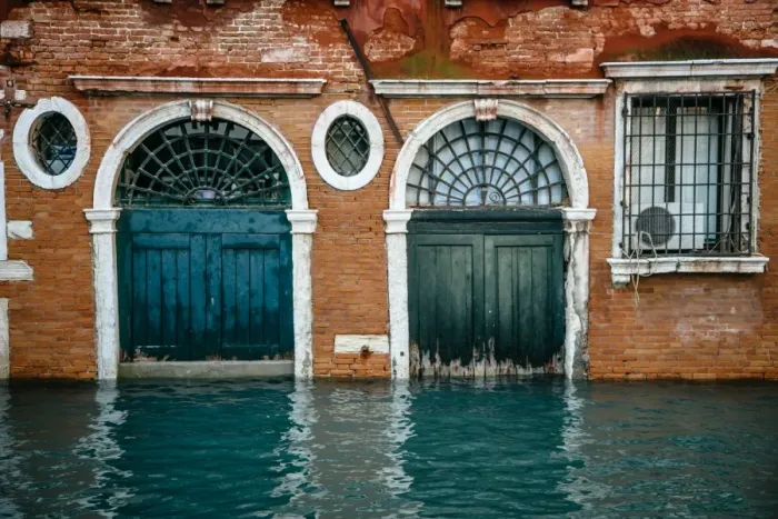 Framed Print : Half sunken doors of townouse by the canal in Venice, Italy Framed Print : Half sunken doors of townouse by the canal in Venice, Italy