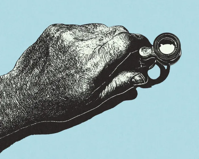 Framed Print : Hand Holding a Magifying Loupe Framed Print : Hand Holding a Magifying Loupe