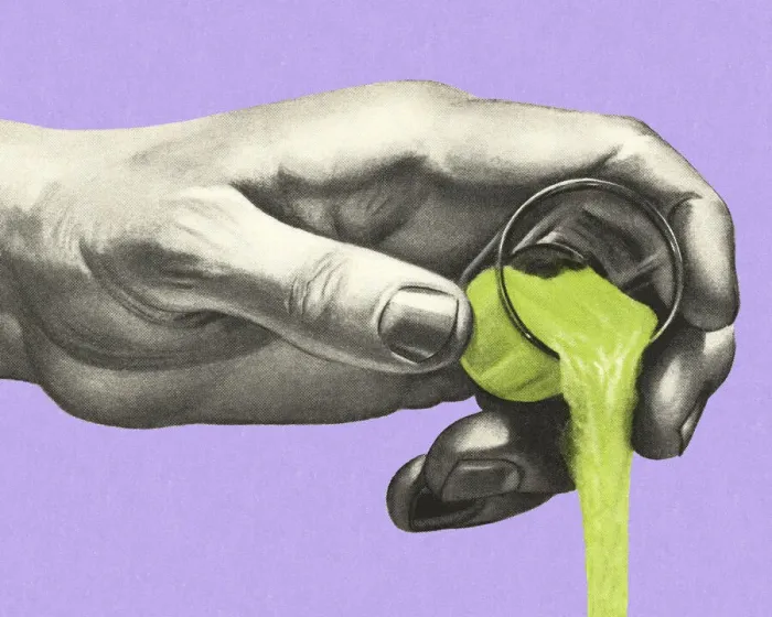 Framed Print : Hand Pouring a Green Liquid