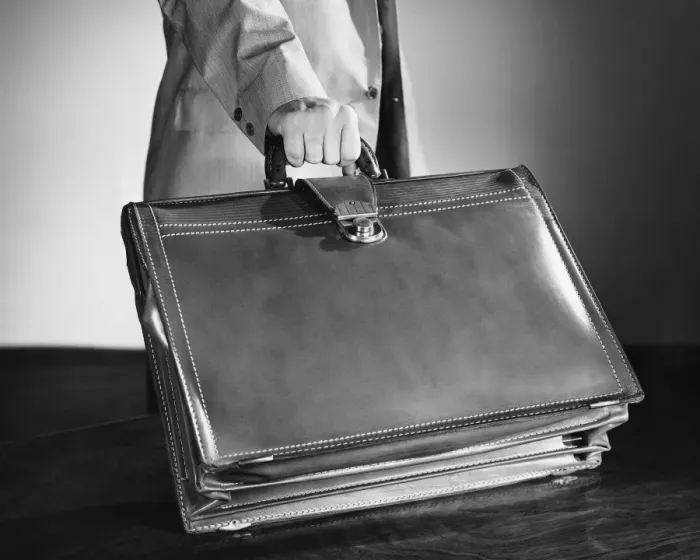 Framed Print : Hand shot of man picking up briefcase Framed Print : Hand shot of man picking up briefcase