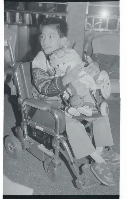 Framed Print : Handicapped Boy Holding New Disabled Doll Framed Print : Handicapped Boy Holding New Disabled Doll