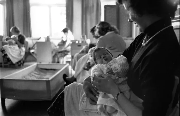 Framed Print : Happy Mum. 25th September 1954: An unmarried mother rocks her baby to sleep Framed Print : Happy Mum. 25th September 1954: An unmarried mother rocks her baby to sleep