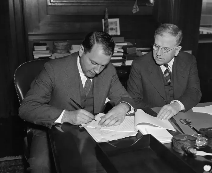 Framed Print : Harold Ickes Signing Contract with Juan Trippe