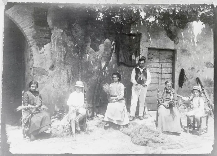 Framed Print : Hat Makers Sitting Outside in Front of Building Framed Print : Hat Makers Sitting Outside in Front of Building